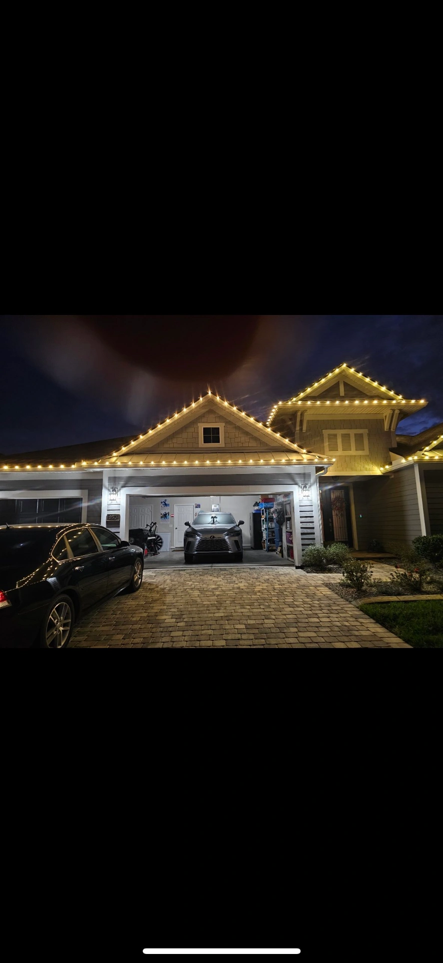 Warm white roofline holiday lights on craftsman home
